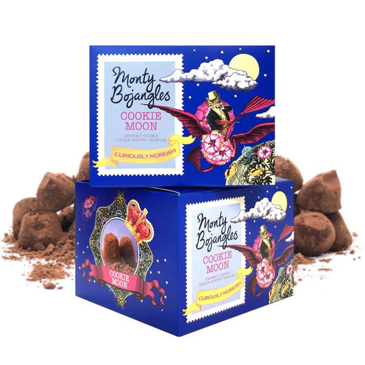 Twee opgestapelde doosjes in de kleur kobaltblauw. Erin zitten de Monty Bojangles Cookie Moon chocoladetruffels.